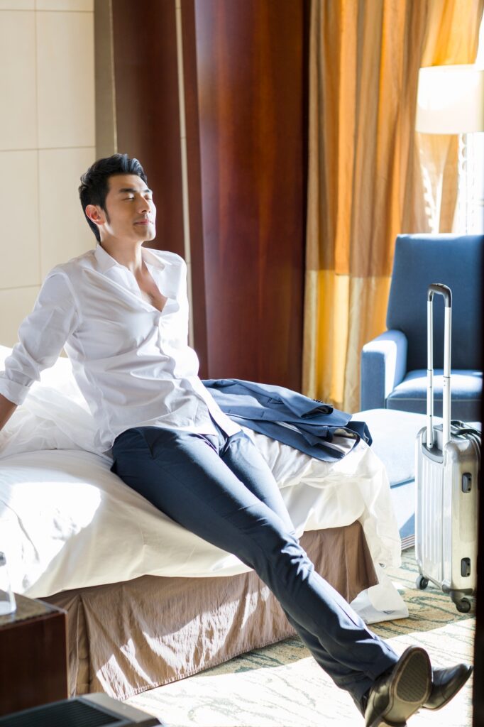 Young businessman resting in hotel room
